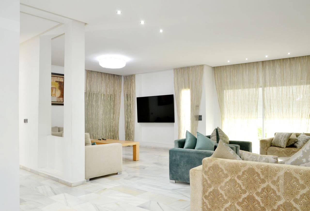 Crafting Captivating Headlines: Your awesome post title goes here Spacious modern living room with elegant sofas and stylish decor.